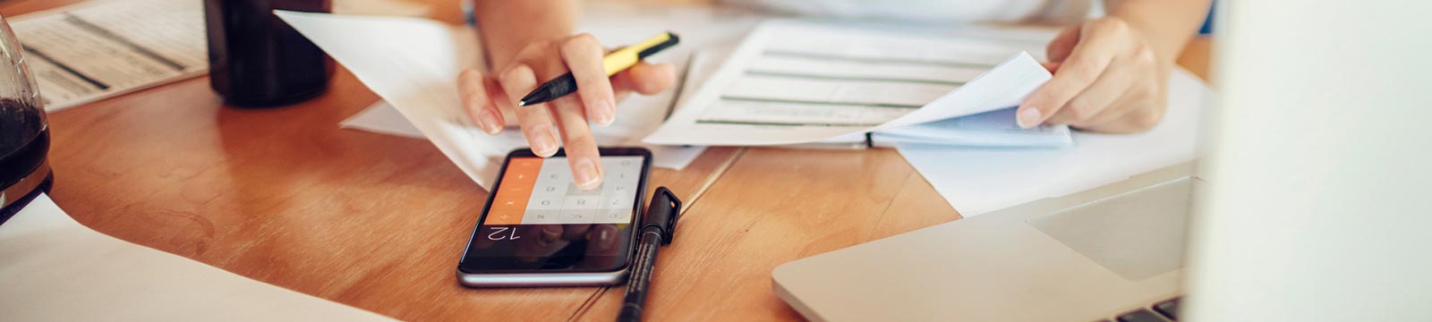 Person using calculator to do finances.