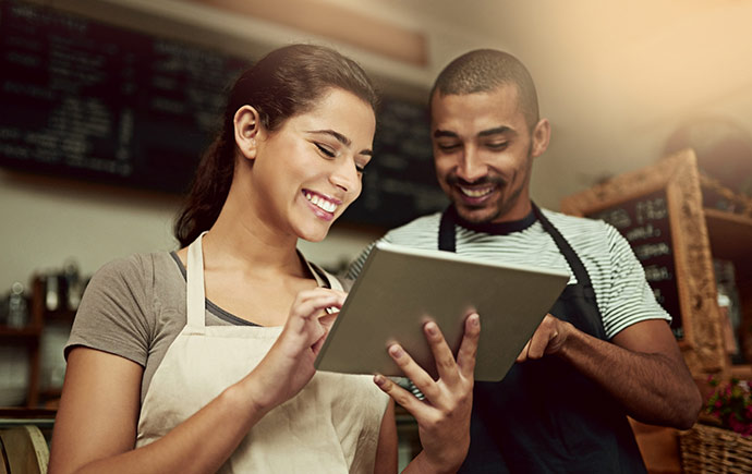 Small business partners checking their finances on a tablet.